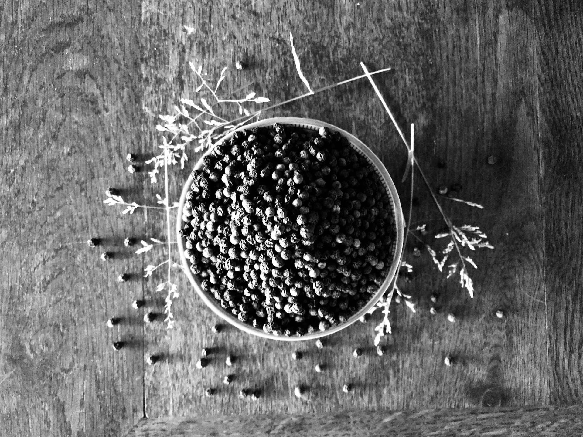 a bowl filled with seeds on top of a wooden table